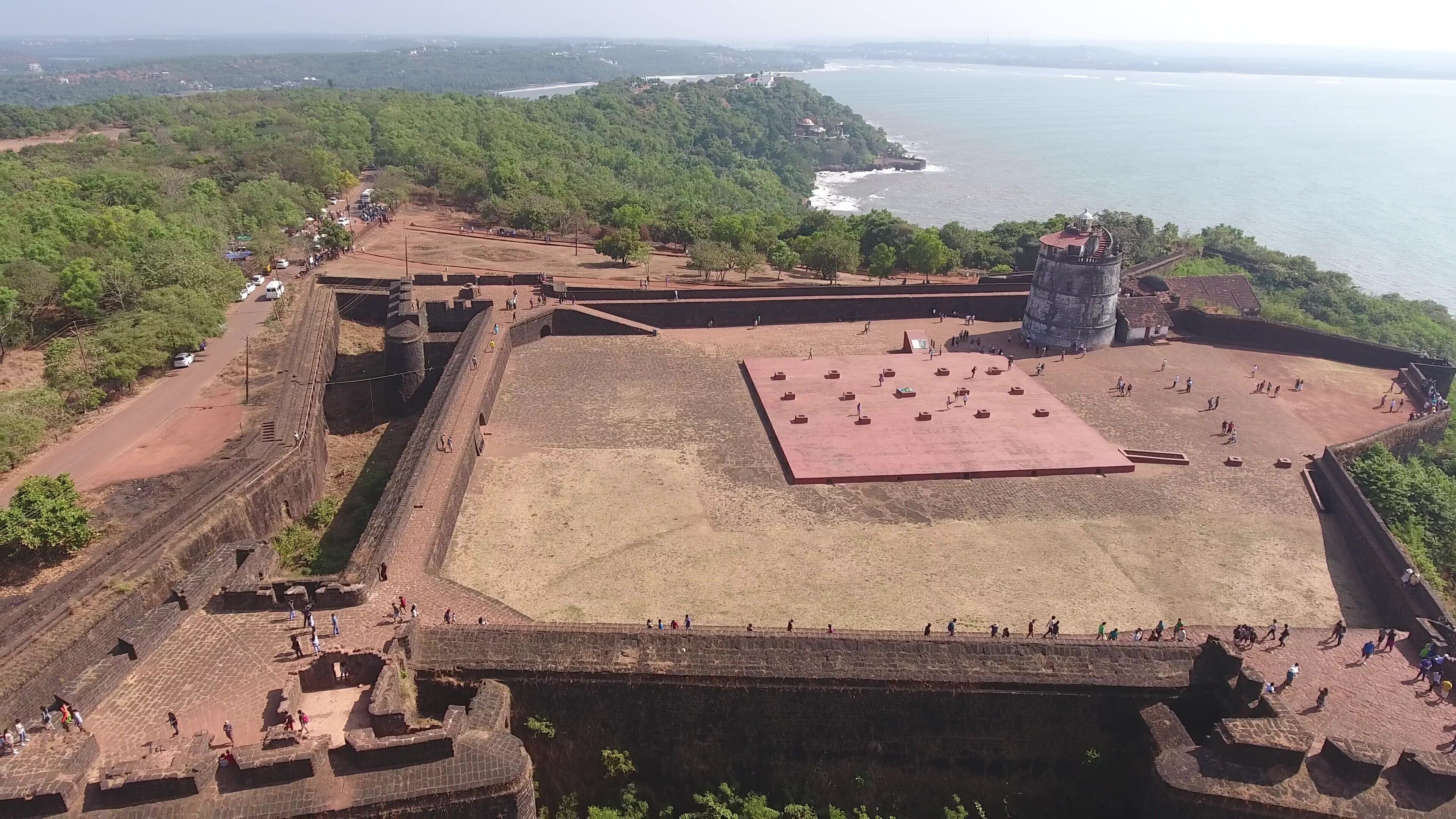 An ancient fort with a large open courtyard, surrounded by high walls and a watchtower.