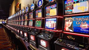 A row of slot machines with illuminated screens and a sign reading "Pirate's Jackpot". - Zia Park Hotel (Hobbs)