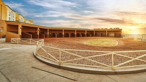 A large, open-air structure with multiple levels of seating and a central open area. - Zia Park Hotel (Hobbs)