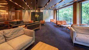 A modern interior with a sofa, armchairs, and a coffee table. - Minamitei (Izumisano)