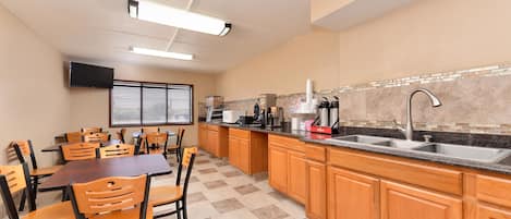 A kitchen with wooden cabinets, a granite countertop, and a built-in sink.