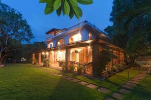 A two-story house with a covered porch and a well-maintained lawn. - Amihan-Home (Boracay Island)