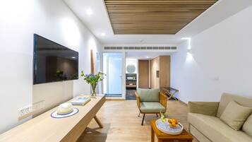 Executive Suite | Living area | 43-inch flat-screen TV with satellite channels, TV