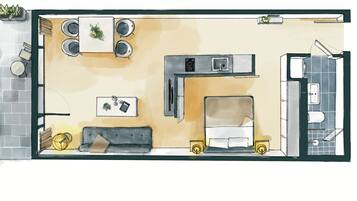 A kitchen with a dining area, a sofa, and a small table with plants.