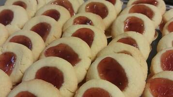 A tray of round cookies with a red filling.