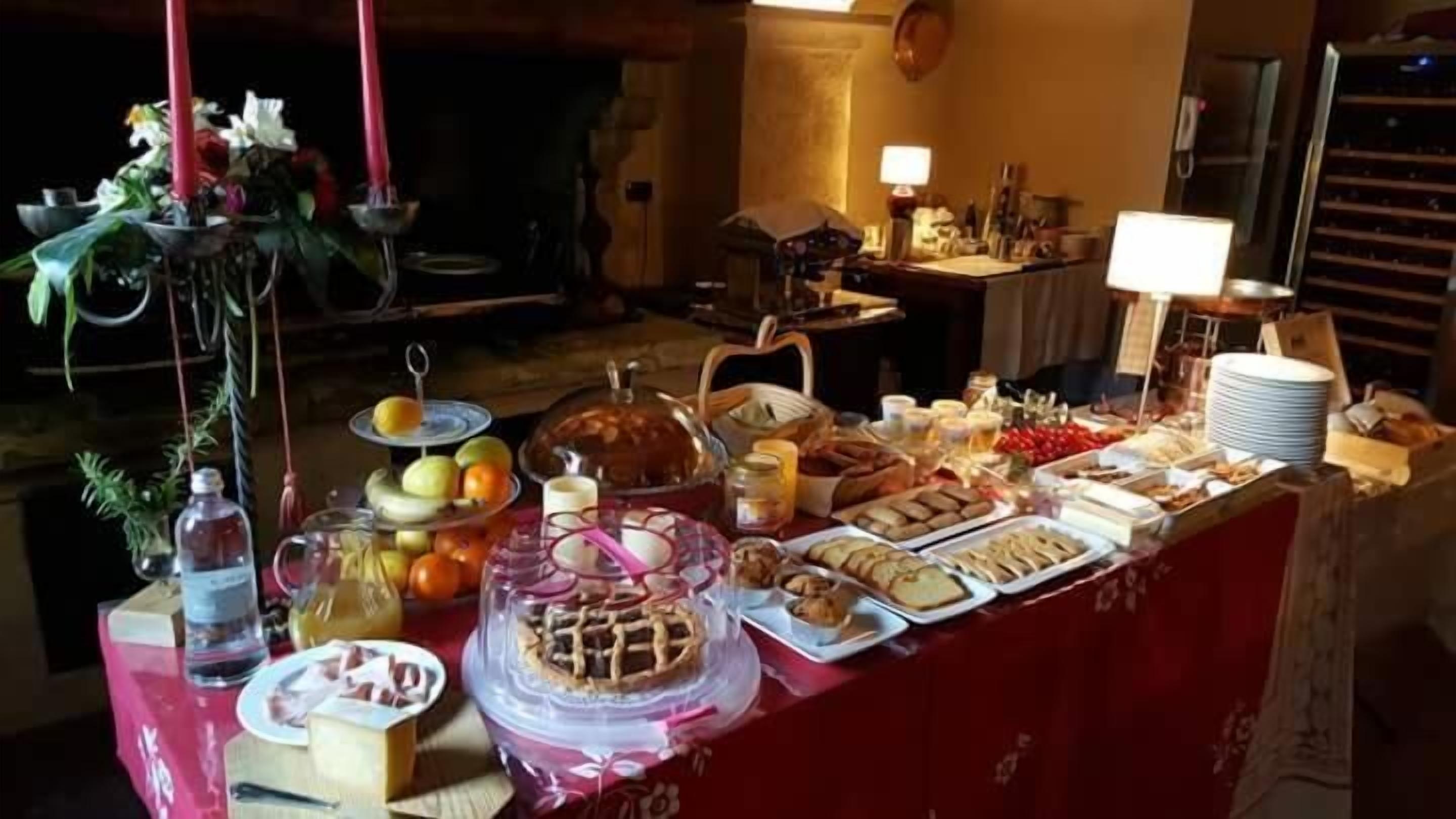 A buffet table with various food items and a decorative centerpiece.