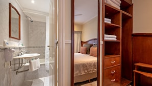 Ein Hotelzimmer mit Bad, Bett und Kleiderschrank.