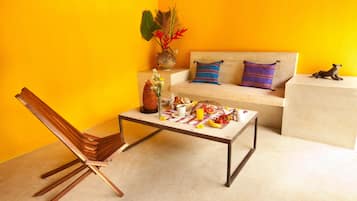 A living room with a sofa, a coffee table, and a chair.