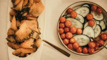 A white plate with sliced vegetables and a fork.