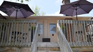 A gated entrance with two doors, each marked with a number, and two large umbrellas.