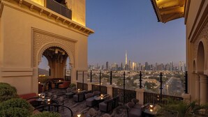 A rooftop terrace with outdoor seating and a view of the city skyline. - Four Seasons Resort Dubai at Jumeirah Beach (Dubai)