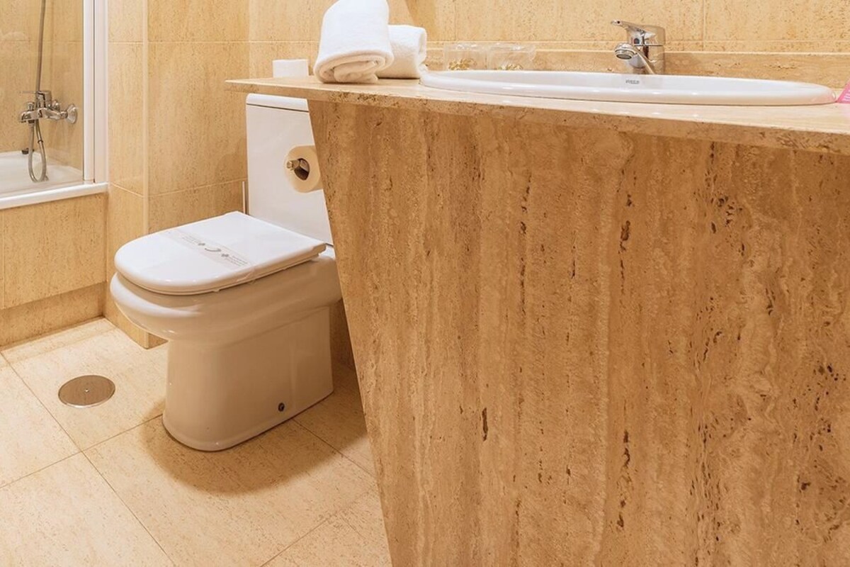 A bathroom with a bathtub, toilet, and sink.