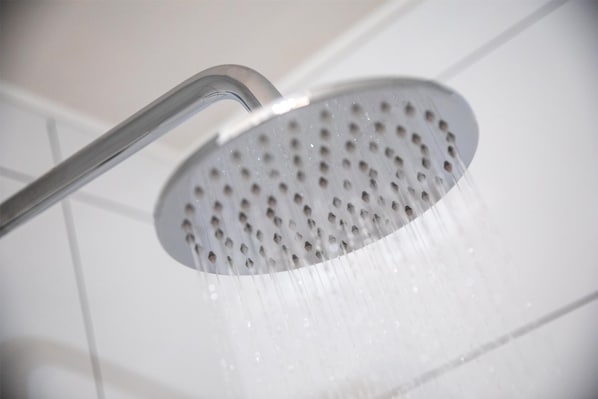 A showerhead with water flowing from it. - Nightcap at the Ranch Hotel (Marsfield)