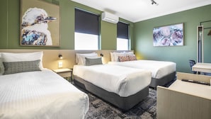 A hotel room with two beds, a desk, a chair, and artwork on the walls. - Nightcap at Pritchards Hotel (Mt Pritchard)