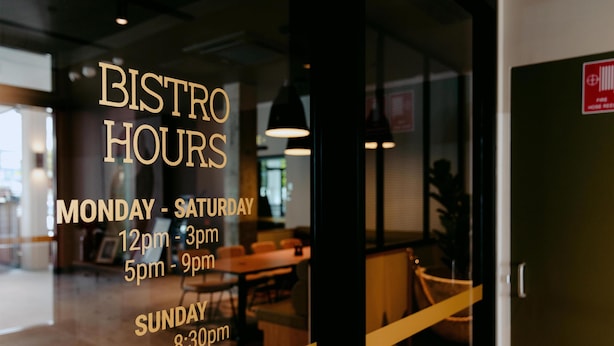 A window with bistro hours listed: Monday-Saturday 12pm-3pm, 5pm-9pm; Sunday 12pm-8:30pm. - Nightcap at Pritchards Hotel (Mt Pritchard)