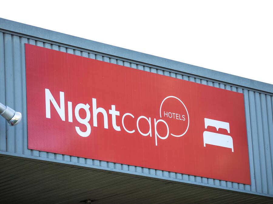 A red sign with the text "Nightcap Hotels" and a bed icon, indicating a hotel.