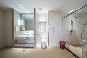 A modern bathroom with a glass shower enclosure, a white toilet, and a marble vanity. - Fuxing Oriental Boutique Hotel (Chifeng)
