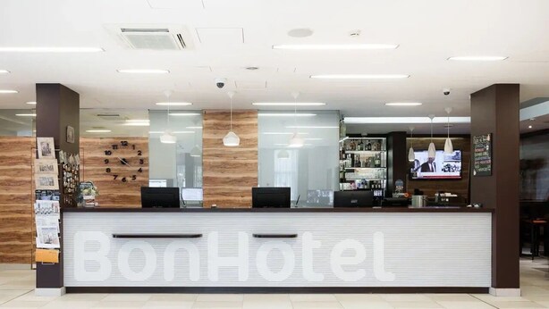 A reception desk with the name "BonHotel" prominently displayed. - Bonhotel (Minsk)
