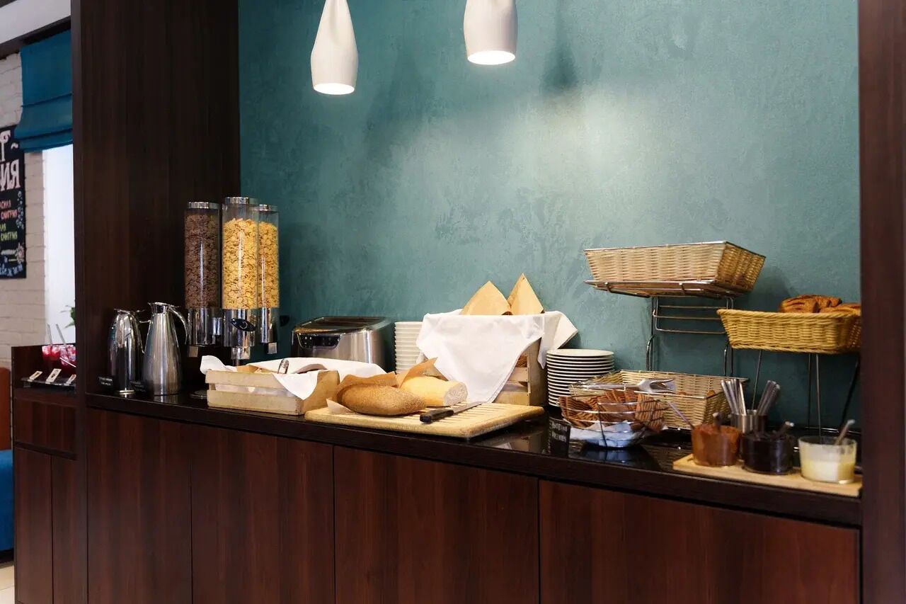 Un buffet proposant une variété d’aliments, de paniers et d’ustensiles pour le petit-déjeuner.