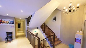 A hotel lobby with a staircase, a chandelier, a waste bin, and a sign indicating the exit. - De UPTOWN Hotel @ Subang Jaya (Subang Jaya)