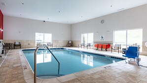 A swimming pool with a lifeguard chair, pool lift, and a clock on the wall. - Holiday Inn Express & Suites Ironton by IHG (Ironton)