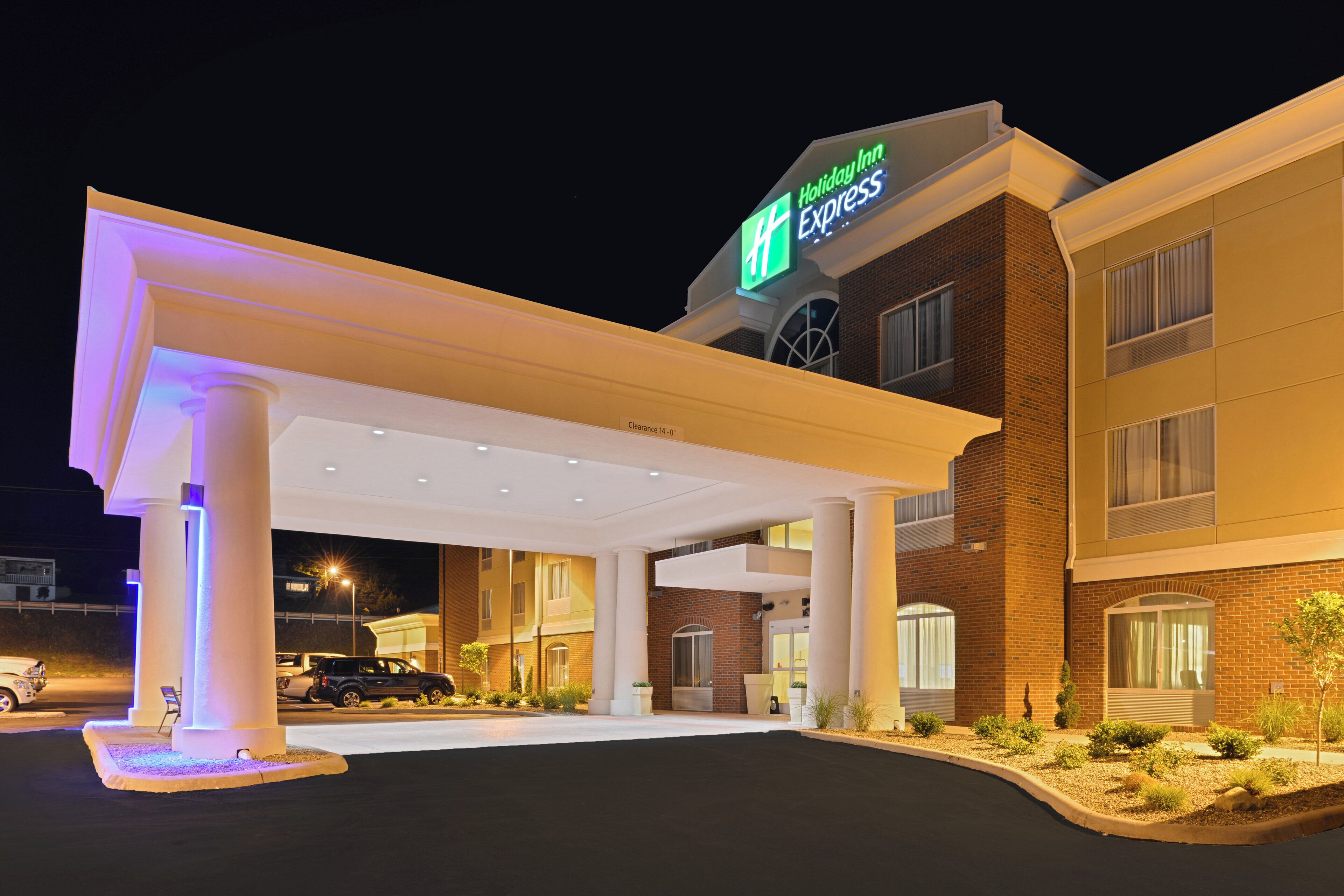 A Holiday Inn Express hotel with a covered parking area, multiple entry points, and a brick facade.