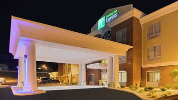 A Holiday Inn Express hotel with a covered parking area, multiple entry points, and a brick facade.