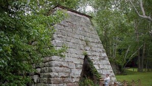 A stone structure with a small opening, surrounded by greenery and a chain-link fence. - Holiday Inn Express & Suites Ironton by IHG (Ironton)