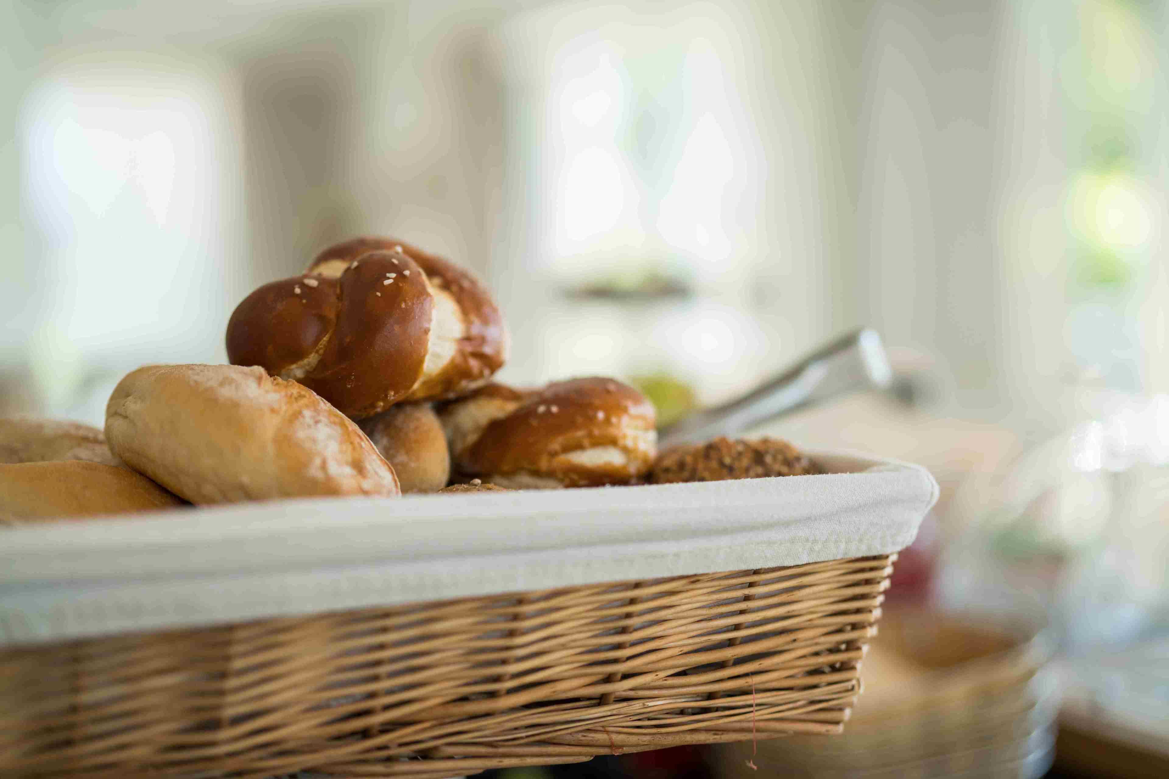 A wicker basket containing various baked goods, likely for a breakfast or snack setting.