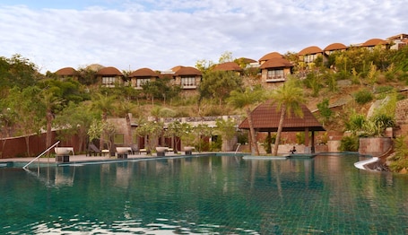 Outdoor pool, pool umbrellas. The Ananta Udaipur