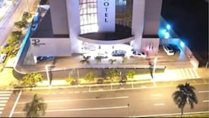 Een modern hotel met een centraal atrium en een opvallend 'HOTEL' bord.