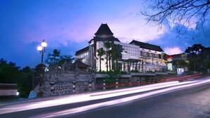 A building with a traditional architectural style, featuring a prominent tower and multiple windows. - Hotel Neo Denpasar by ASTON (Denpasar)