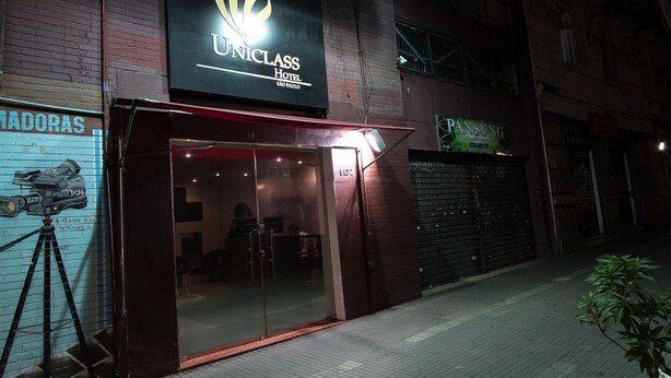 The exterior of the Uniclass Hotel in Sao Paulo, featuring a prominent sign, a glass entrance, and a camera on a tripod outside. - Oyo Uniclass Hotel Centro SP (Sao Paulo)
