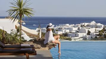 Relax by the pool overlooking the coastal town with stunning views.