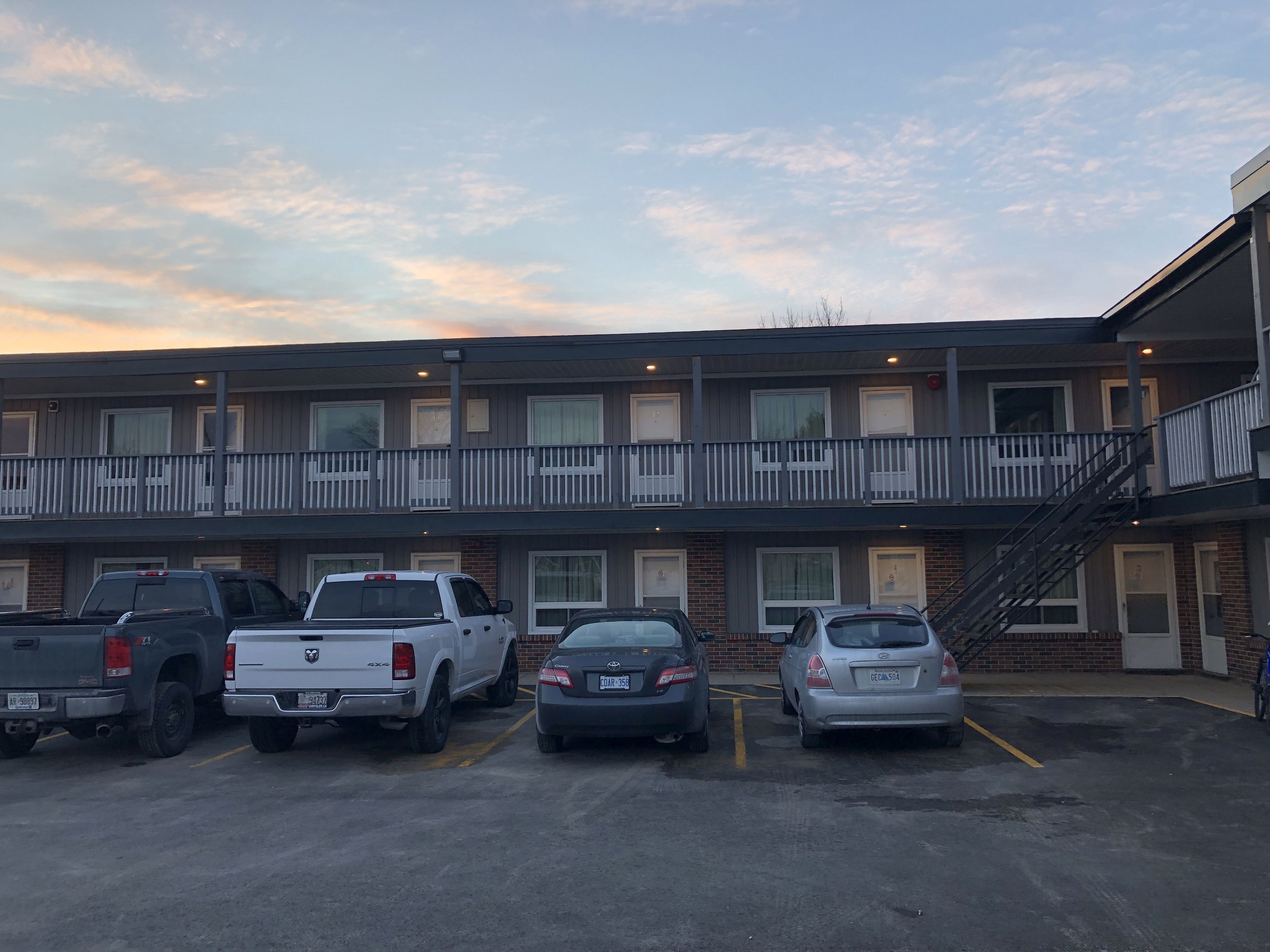 A multi-story motel with a parking lot.