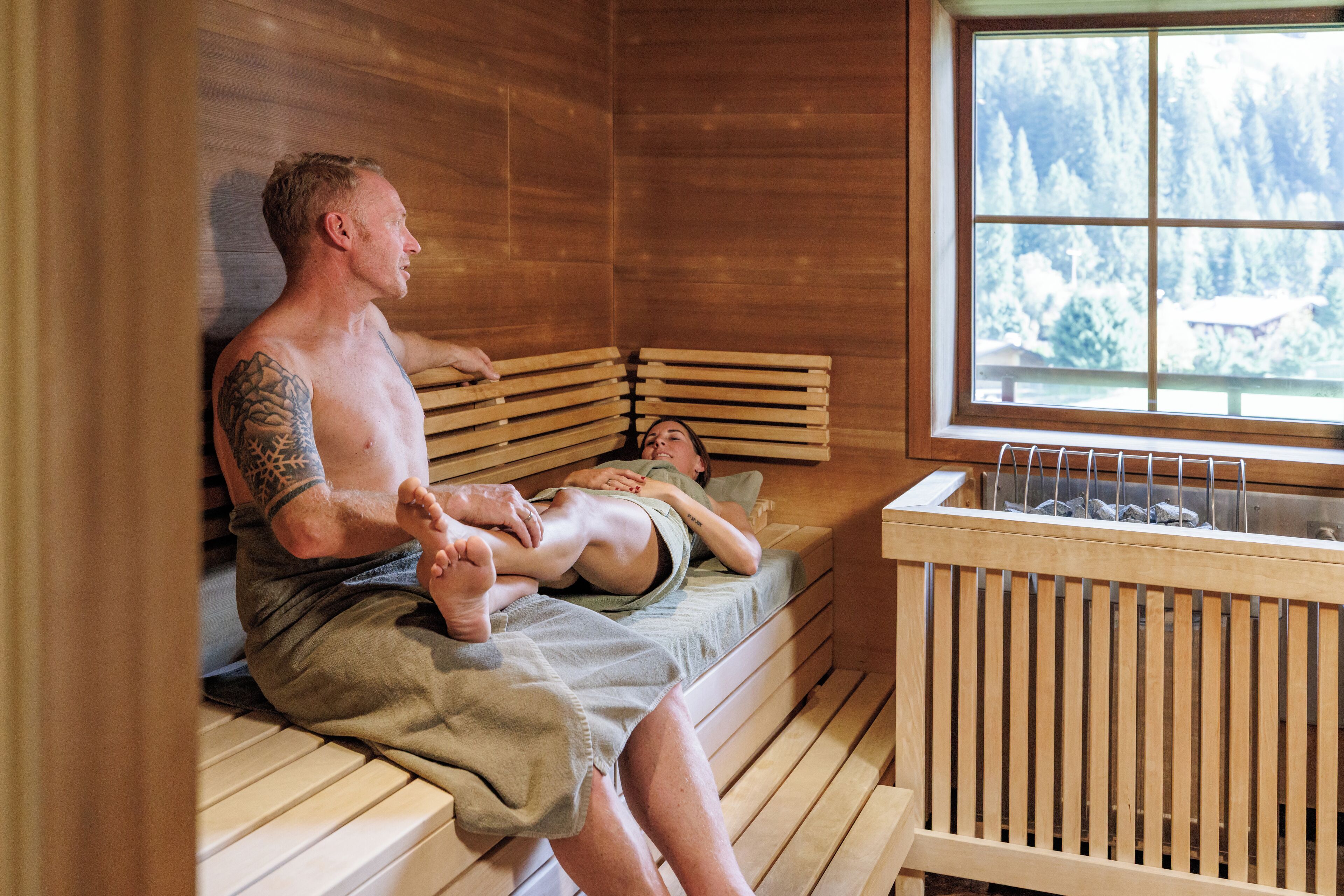 A sauna room with wooden benches and a window.