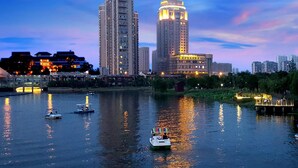 A river with boats and a cityscape in the background.