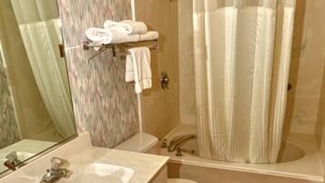 A bathroom with a sink, toilet, and shower.
