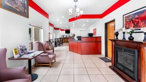 A hotel lobby with a reception desk, seating area, and a fireplace. - Econo Lodge Panguitch Near Bryce Canyon (Panguitch)