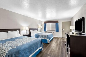 A hotel room with two beds, a TV, a desk, and a window with curtains. - Econo Lodge Panguitch Near Bryce Canyon (Panguitch)