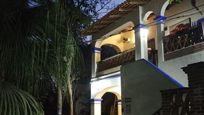 A two-story building with a staircase leading to the upper level. - Hotel & Temazcal Hacienda de Melaque (San Patricio Melaque)