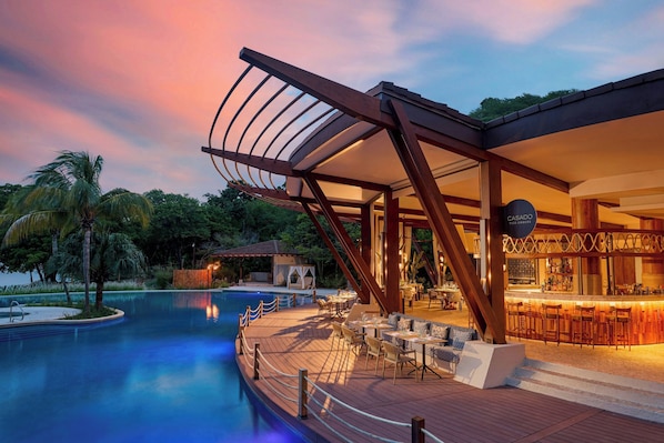 A poolside area with a bar and outdoor seating.