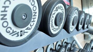 A rack of dumbbells with visible weight markings and the brand name "CONNOY TECHNOLOGY".