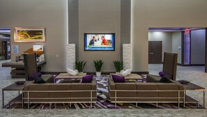 A modern lobby with a large flat-screen TV, comfortable seating, and a reception desk. - Holiday Inn Express & Suites Garland E - Lake Hubbard I30 by IHG (Garland)