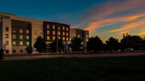 A multi-story hotel with a modern design, featuring a prominent sign for the Hilton Express brand. - Holiday Inn Express & Suites Garland E - Lake Hubbard I30 by IHG (Garland)