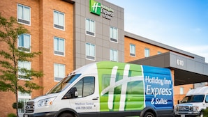 A Holiday Inn Express & Suites building with a brick facade and large windows. - Holiday Inn Express & Suites Madison Central by IHG (Madison)
