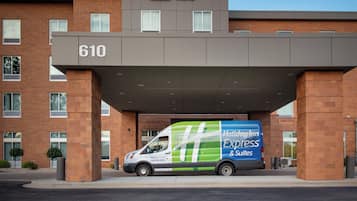 A Holiday Inn Express & Suites building with a brick facade and a large sign displaying the number 610.