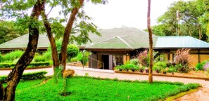 Set amidst lush greenery, this charming building features a welcoming entrance and beautifully maintained grounds.