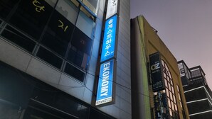 A building with multiple signs, including one for a guest house and another for a hostel. - Sol Guest House Haeundae (Busan)
