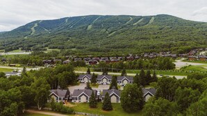 Un barrio residencial con casas, una calle y una montaña al fondo.